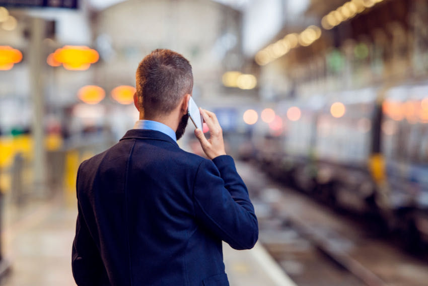 Business traveller train station on mobile